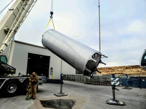 Novid stainless steel cone bottom chemical tank being installed by crane